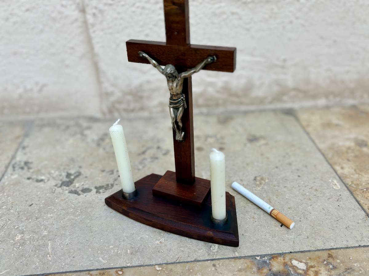 Vintage wooden crucifix with candles