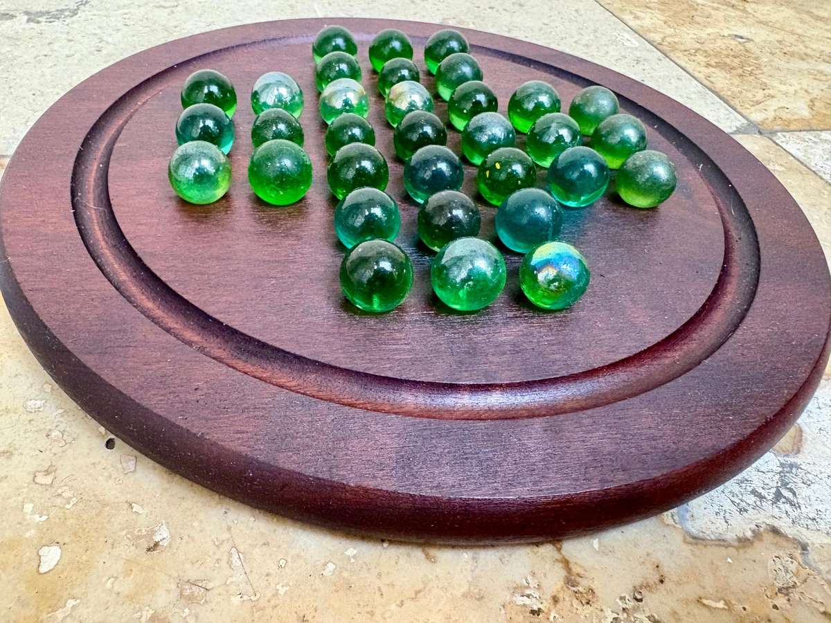 Solitaire game wood green glass marbles