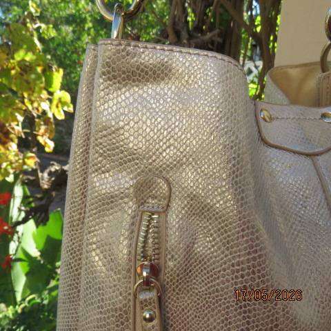 Miss Cassidy gold shoulder bag with gold buckle decoration and vertical front zip