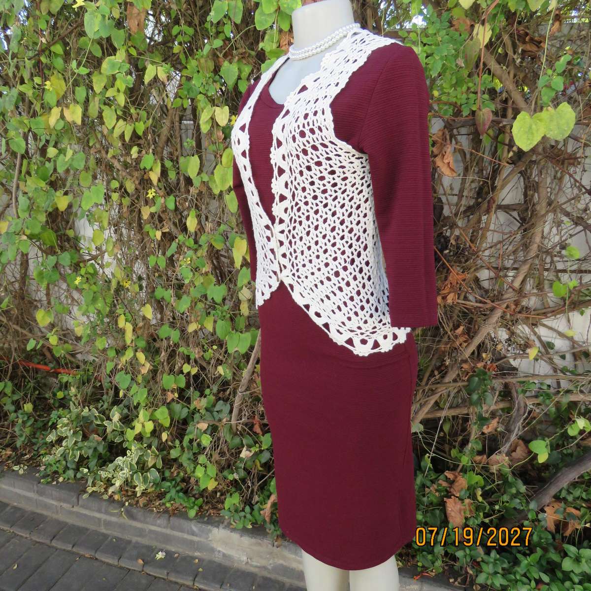 White elegant crochet waistcoat with round edging. The button closure. Size 34-36