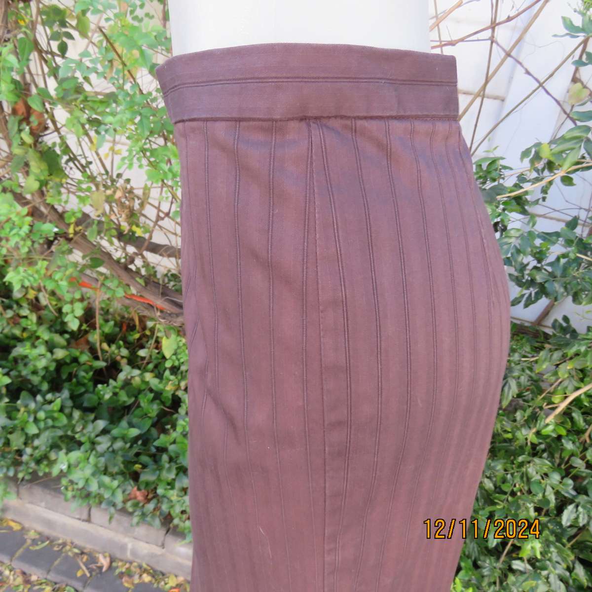 Dark brown striped firm textured stretch polyester pencil lined skirt. Size 38