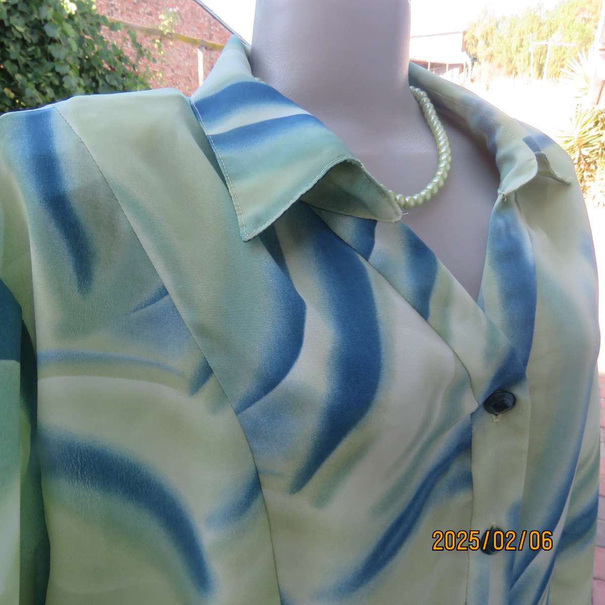 Boutique made silky polyester blue-green patterned size 50 styled top. Open collar.As new