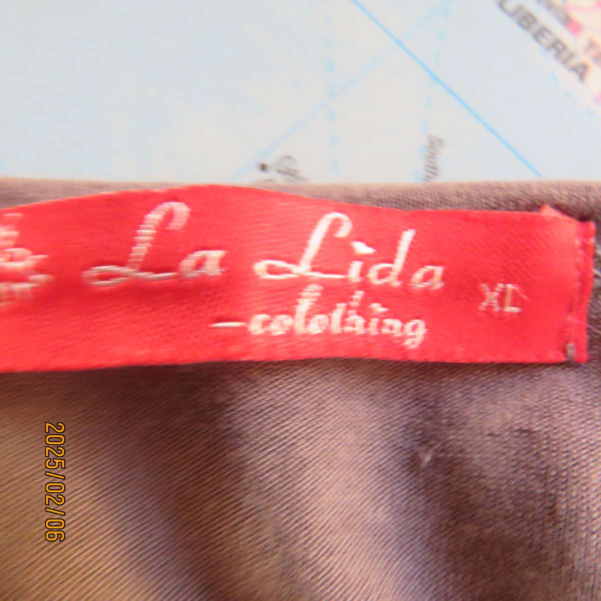 LA LIDA steel grey peplum style stretch polycotton top with white watch patterns. Size 38. As new.