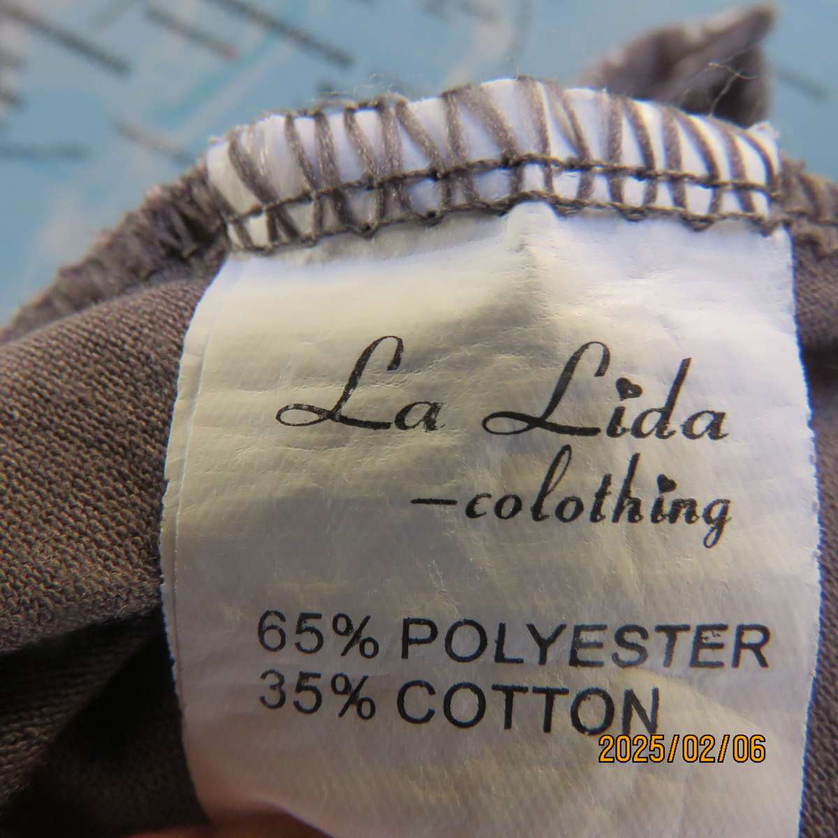 LA LIDA steel grey peplum style stretch polycotton top with white watch patterns. Size 38. As new.