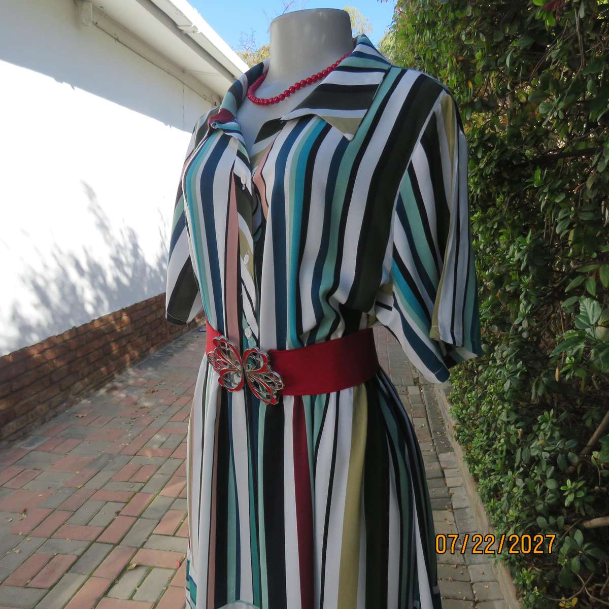 Vertical striped sheath dress in attractive colours. Four button opening. 100% viscose. Size 40