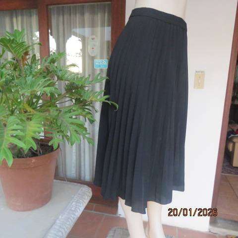 WOOLWORTHS black permanent half flare silky polyester skirt with elasticated waist. Size 40