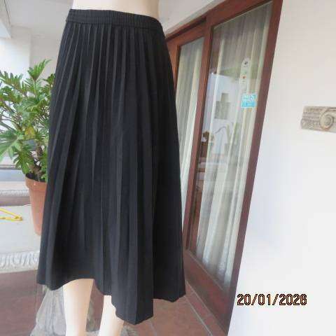 WOOLWORTHS black permanent half flare silky polyester skirt with elasticated waist. Size 40