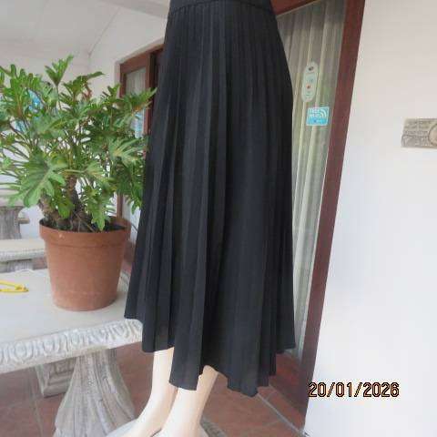WOOLWORTHS black permanent half flare silky polyester skirt with elasticated waist. Size 40