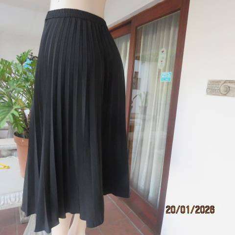 WOOLWORTHS black permanent half flare silky polyester skirt with elasticated waist. Size 40
