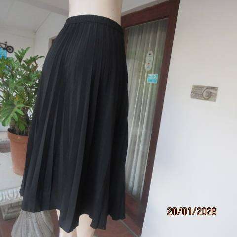 WOOLWORTHS black permanent half flare silky polyester skirt with elasticated waist. Size 40