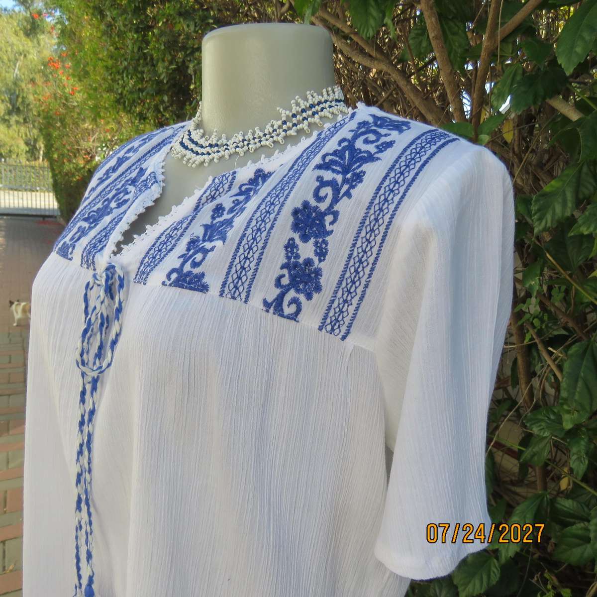 White creased cotton slip over short sleeve top. Blue embroidered front yoke. Size 36