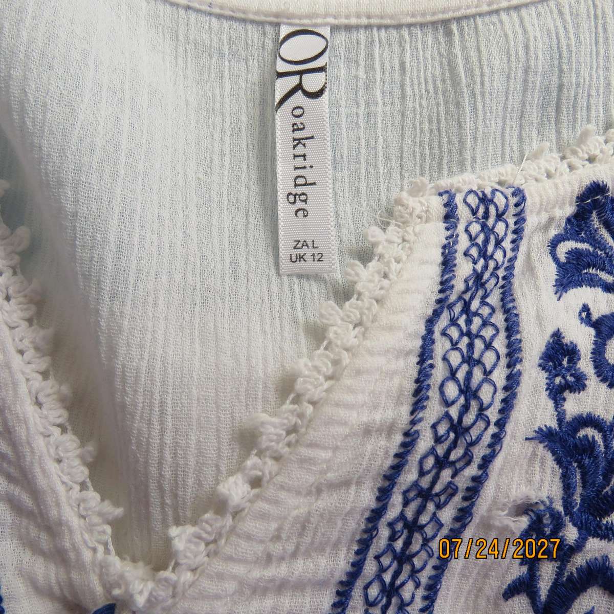 White creased cotton slip over short sleeve top. Blue embroidered front yoke. Size 36