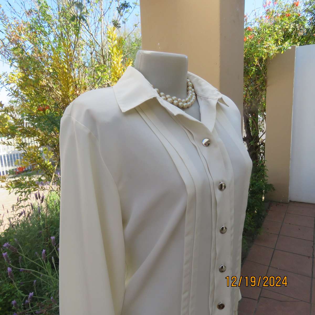Elegant soft cream long cuffed sleeve top. Button down/shirt collar.Decorative tucked seams. Size 36