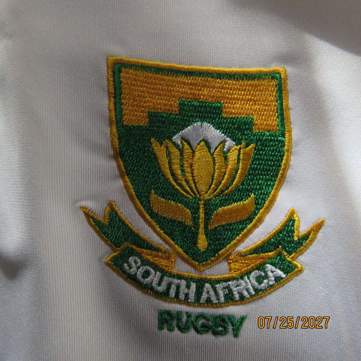 ASICS white SA Rugby stretch polyester top. With dark green-protea badge. Size Med