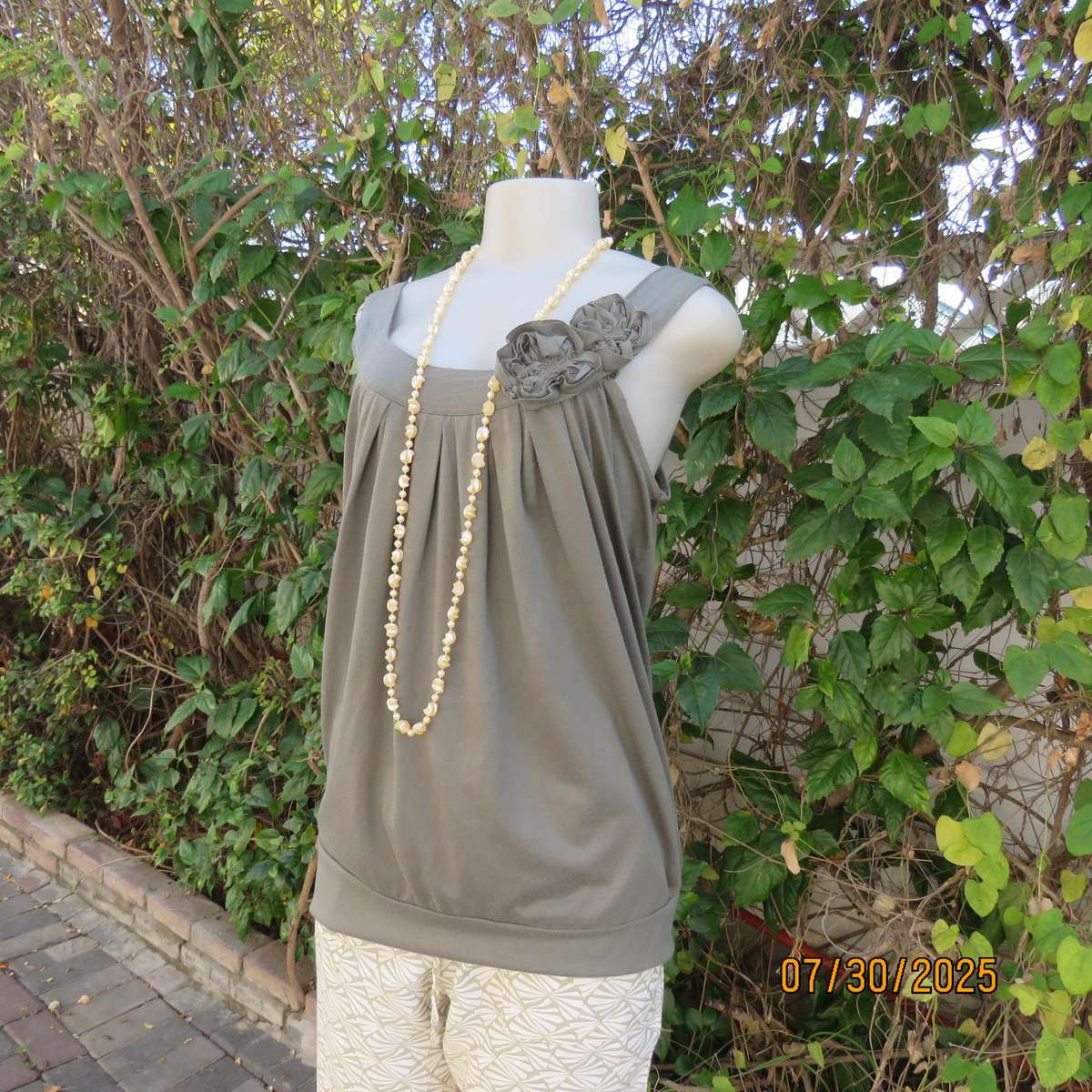 Olive green poly-viscose slip over top with scooped neckline. Pleats on front. Size 38