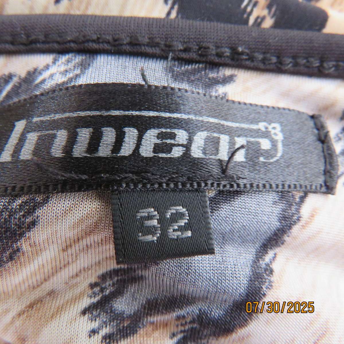INWEAR animal print long sleeve naked shoulder and chrome link top size 32.