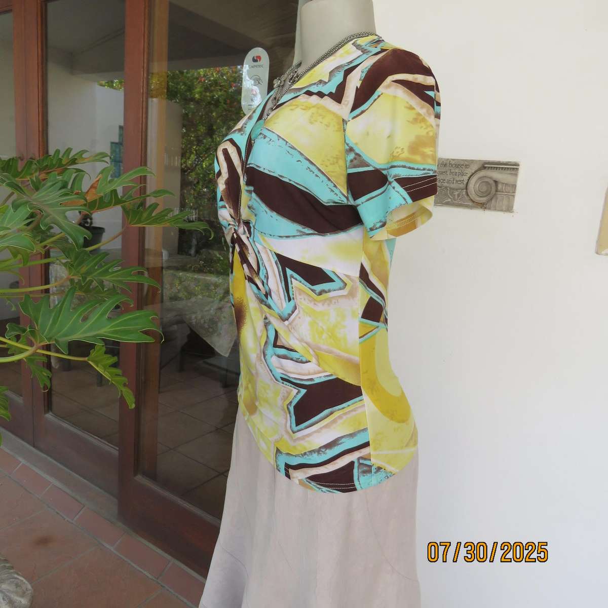 FASHION Express size 38 geometric printed V neck stretch top.
