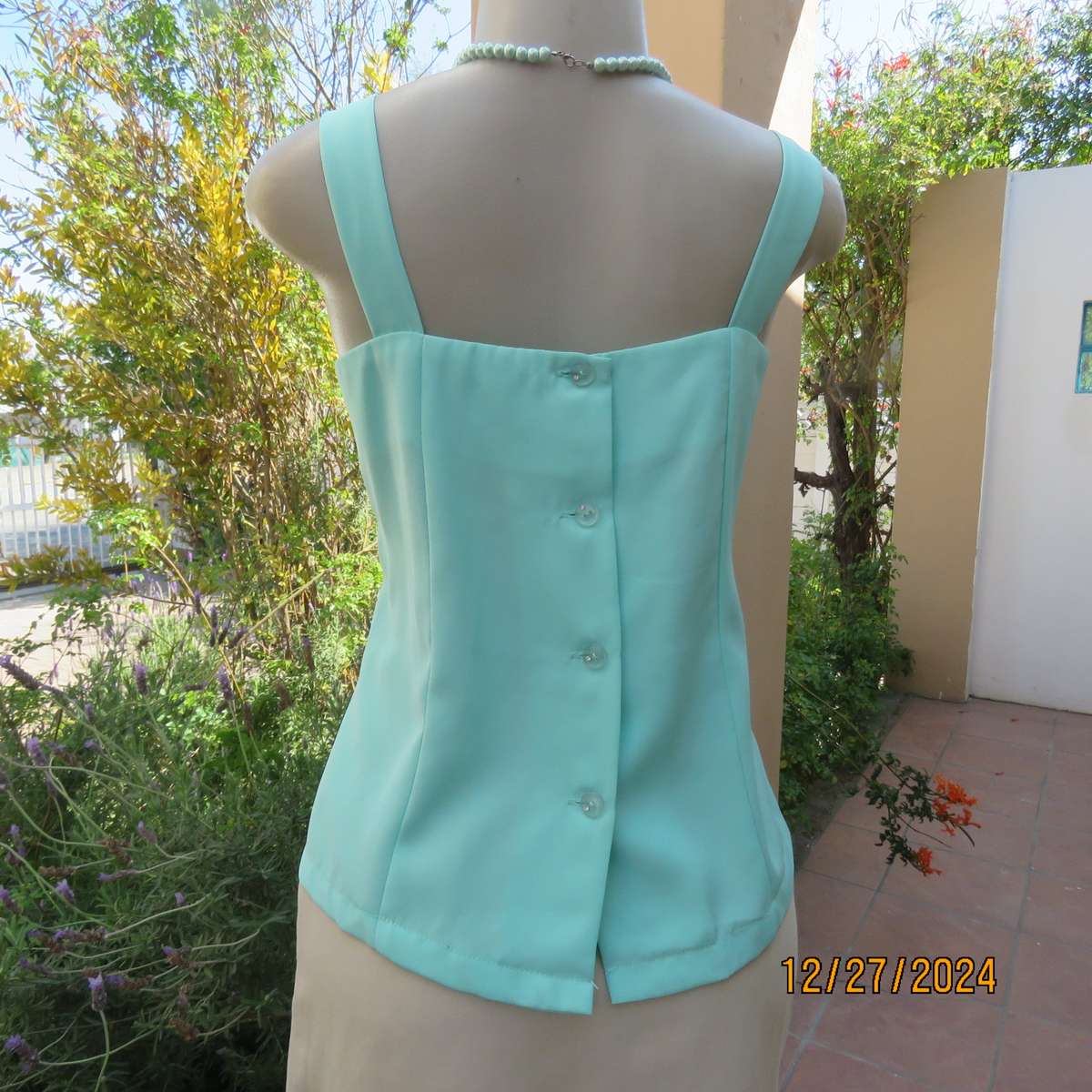 Beautiful emerald green embellished polyester top with shoulder straps. Size 37.Button down back.