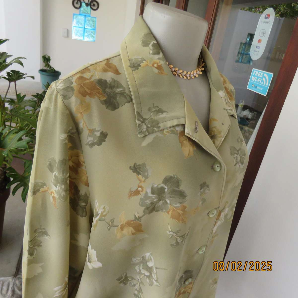 Moss green textured polyester long sleeve top with green-gold flowers. Size 44