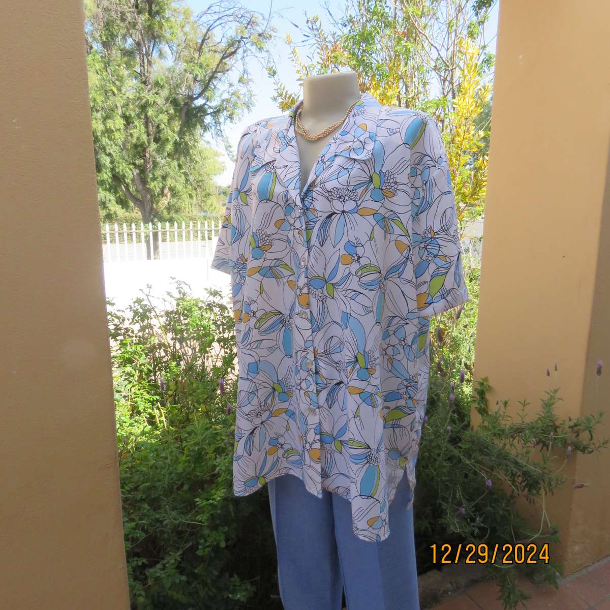 Beautiful CELLINI button down/open collar short sleeve top. Size 48/50.White/blue/peach floral.