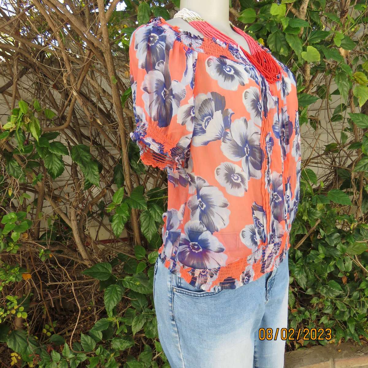 PAPAYA sheer polyester top in salmon with blue flowers. Wide elasticated neckline.Size 38