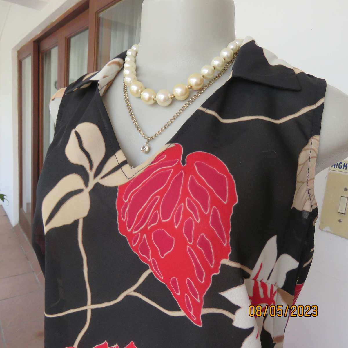 EXACT black sleeveless polyester top with red-cream flowers. Size 34