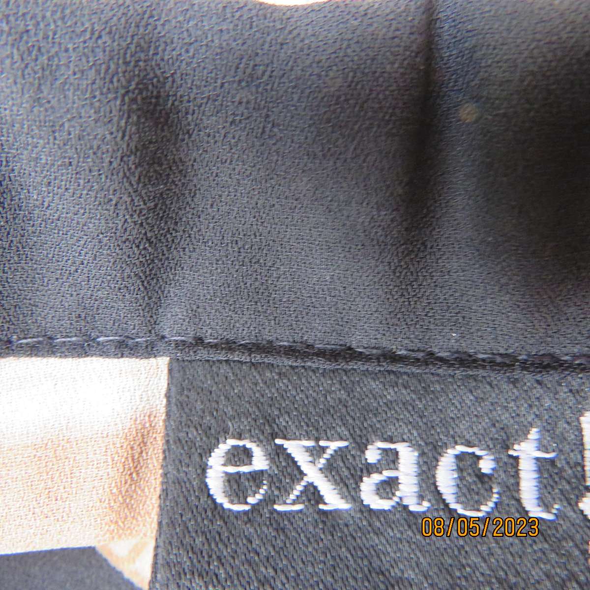 EXACT black sleeveless polyester top with red-cream flowers. Size 34