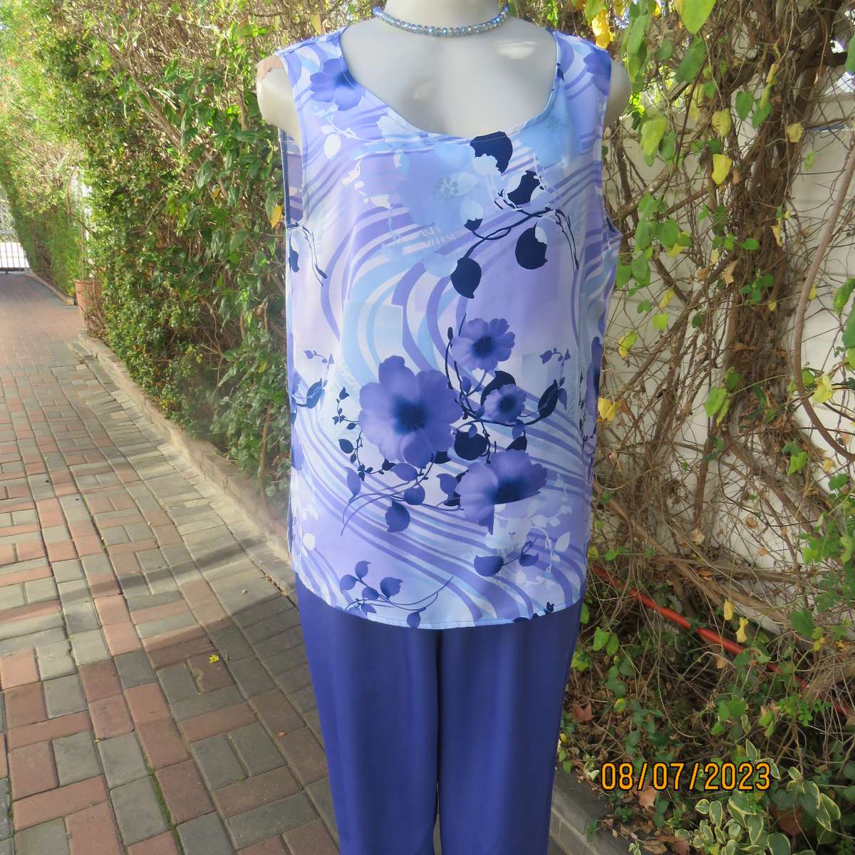 Boutique made sleeveless polyester top in medley of blue colours. Size 36