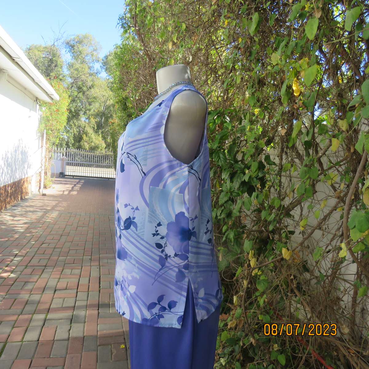 Boutique made sleeveless polyester top in medley of blue colours. Size 36
