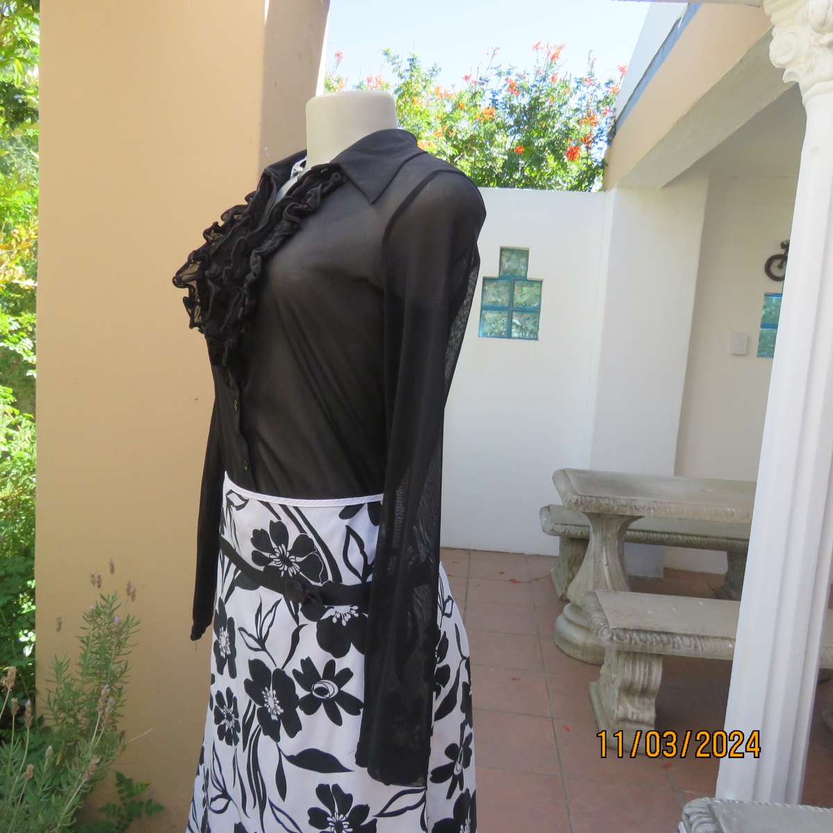 Black stretch nylon long sleeve button down top with frilled bib. Size 36.