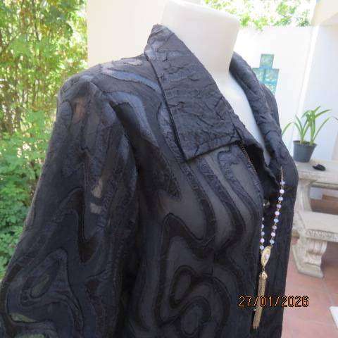 Black opaque embossed sheer polyester button down top with open collar. Size 42.