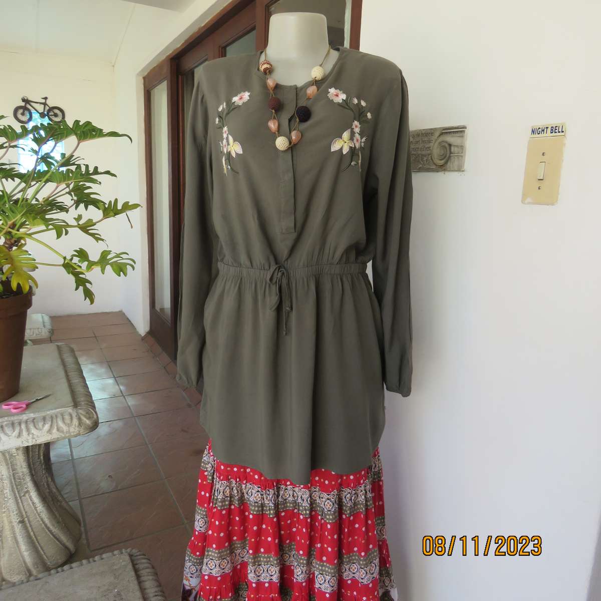 Olive green long viscose top with elasticated waist and front embroidery. Size 40
