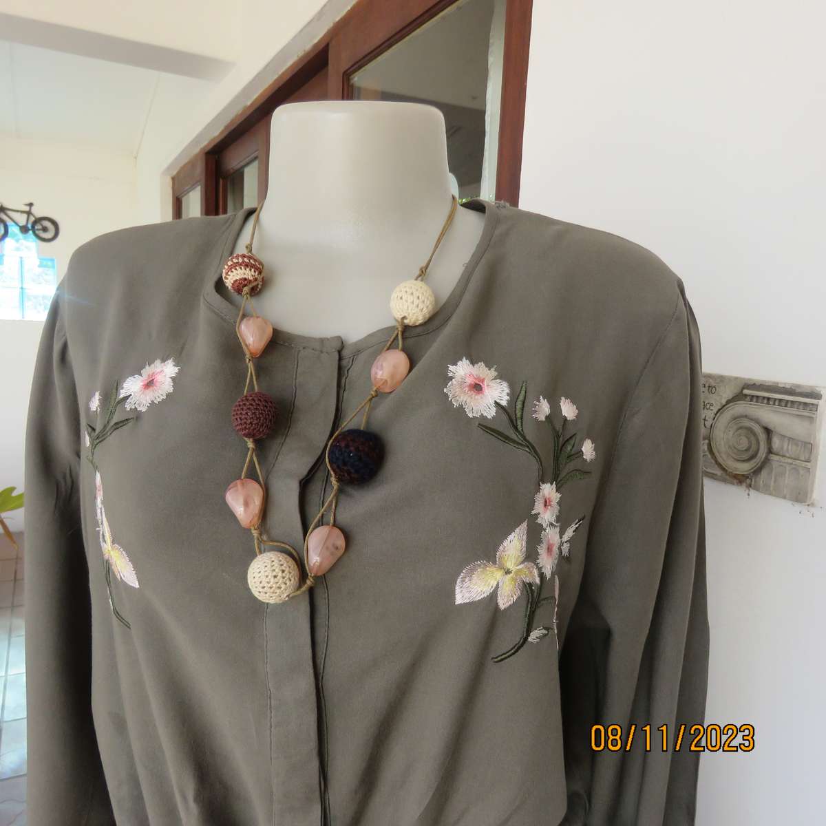 Olive green long viscose top with elasticated waist and front embroidery. Size 40