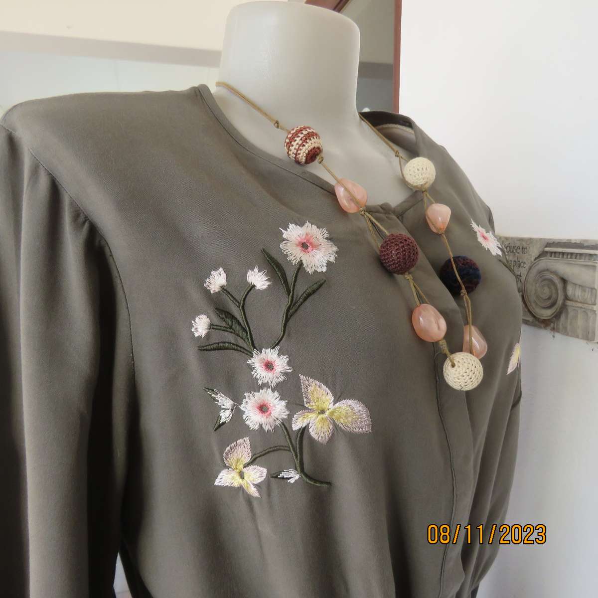 Olive green long viscose top with elasticated waist and front embroidery. Size 40