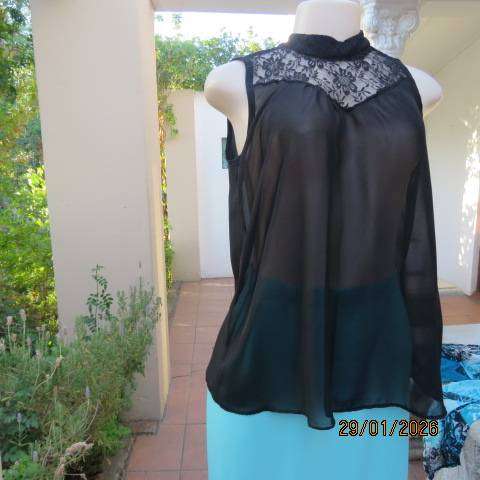 Black sleeveless sheer polyester top with lace front yoke. Opening at back. Size 34