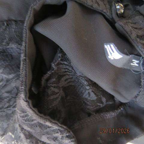 Black sleeveless sheer polyester top with lace front yoke. Opening at back. Size 34
