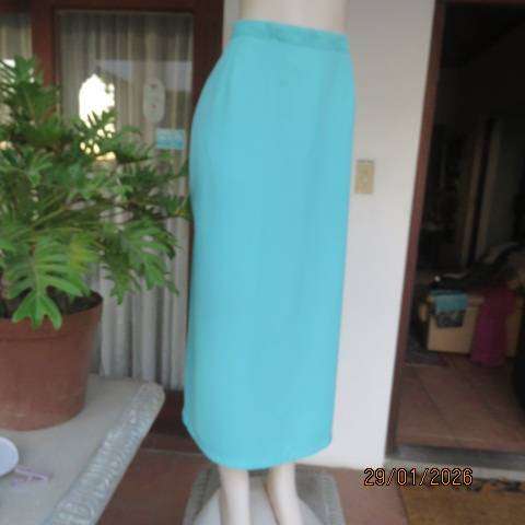 Seagreen ankle length pencil skirt in textured polyester with zip and slit at back. Size 40