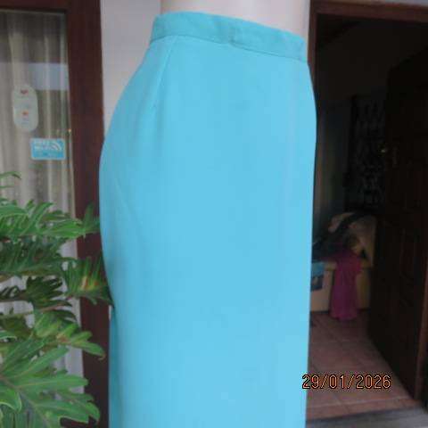 Seagreen ankle length pencil skirt in textured polyester with zip and slit at back. Size 40