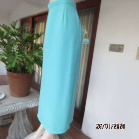Seagreen ankle length pencil skirt in textured polyester with zip and slit at back. Size 40