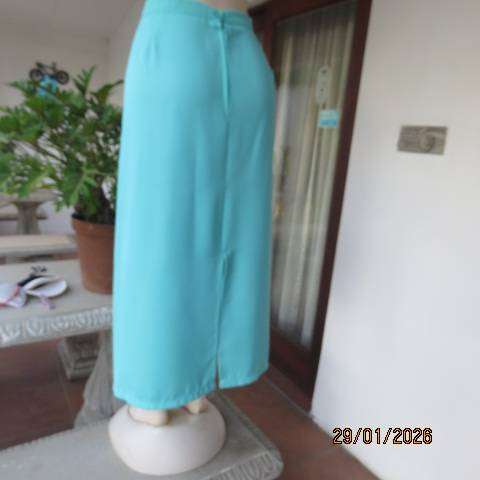 Seagreen ankle length pencil skirt in textured polyester with zip and slit at back. Size 40