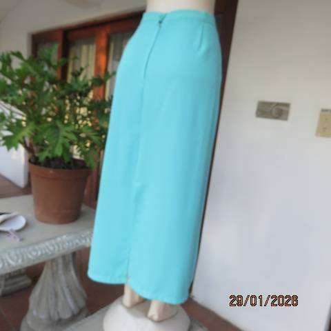 Seagreen ankle length pencil skirt in textured polyester with zip and slit at back. Size 40