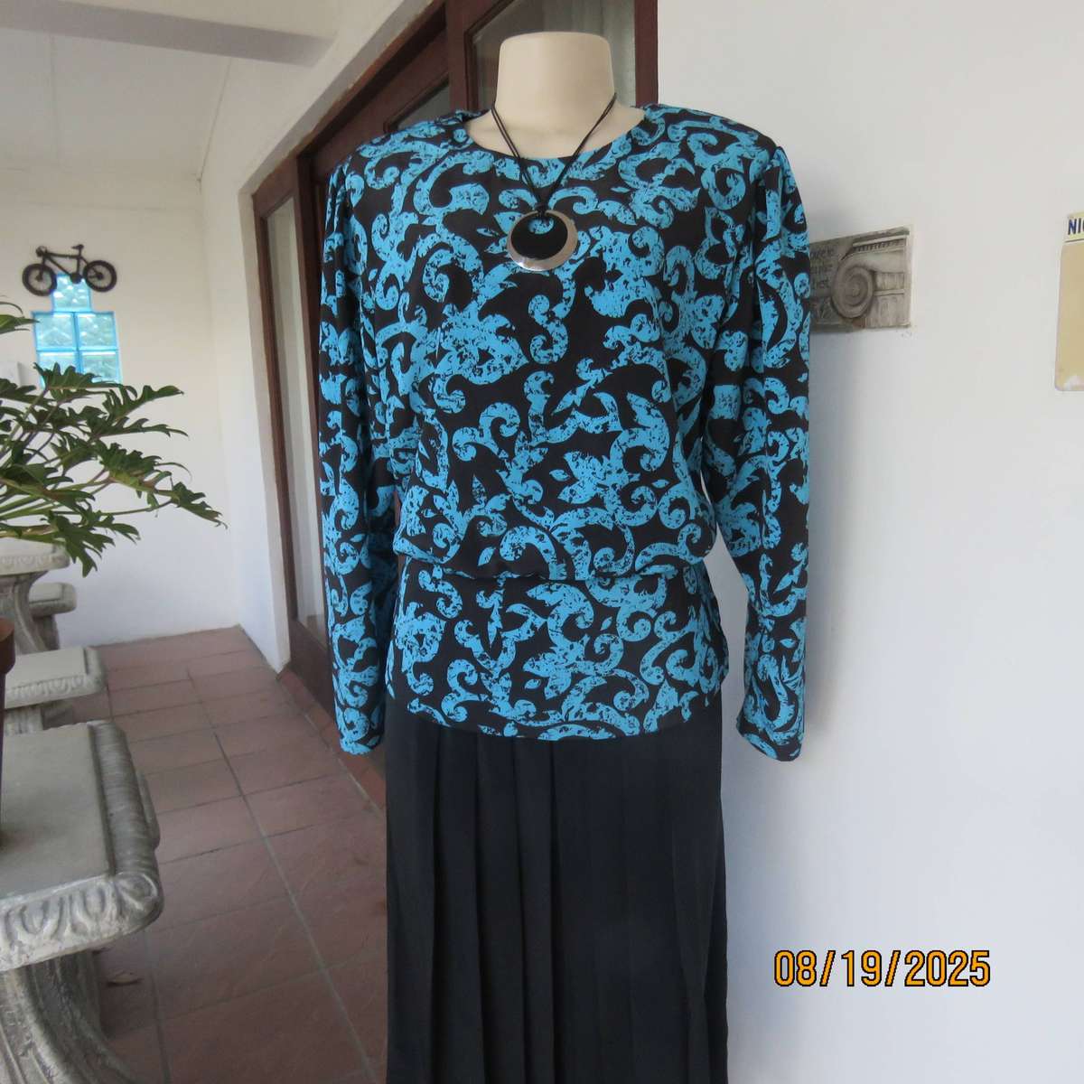 KRESIV peplum style black silky polyester with jade print top. Size 40