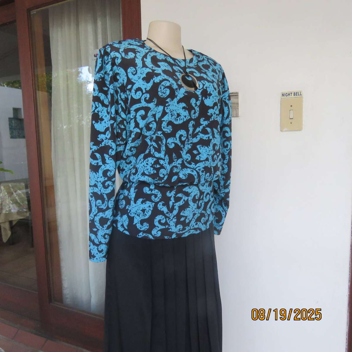 KRESIV peplum style black silky polyester with jade print top. Size 40