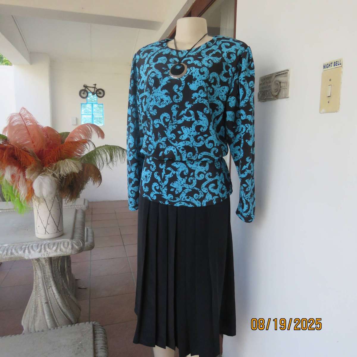 KRESIV peplum style black silky polyester with jade print top. Size 40