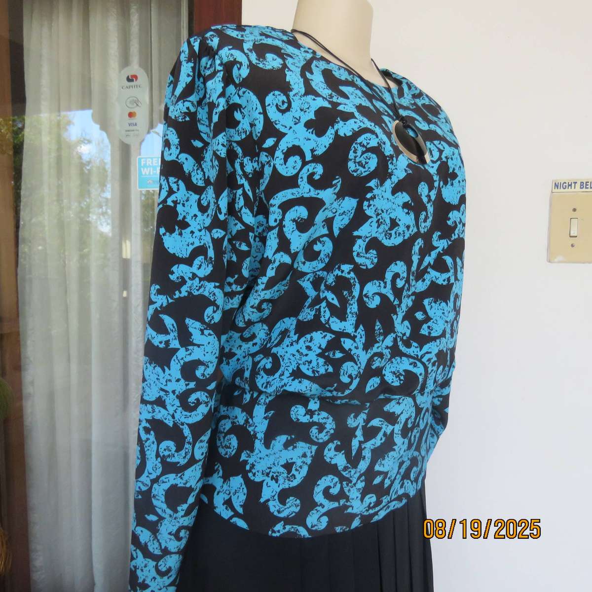 KRESIV peplum style black silky polyester with jade print top. Size 40