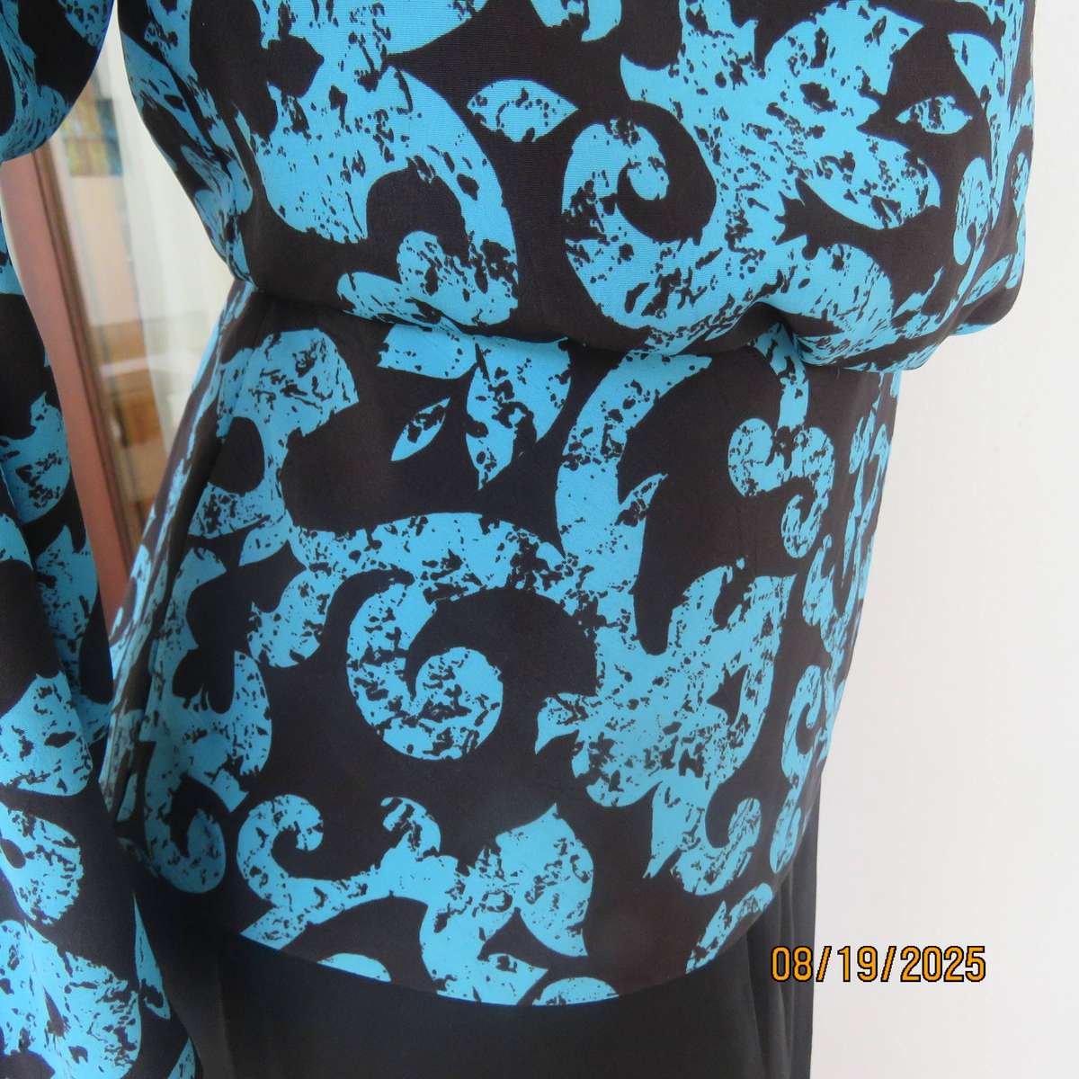 KRESIV peplum style black silky polyester with jade print top. Size 40