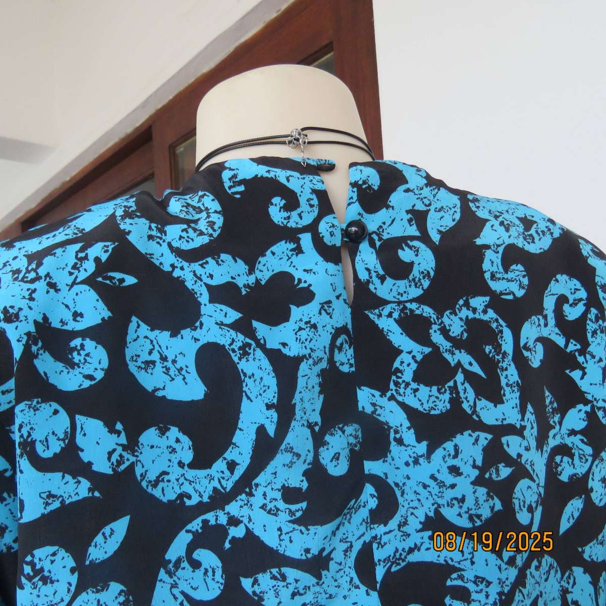KRESIV peplum style black silky polyester with jade print top. Size 40