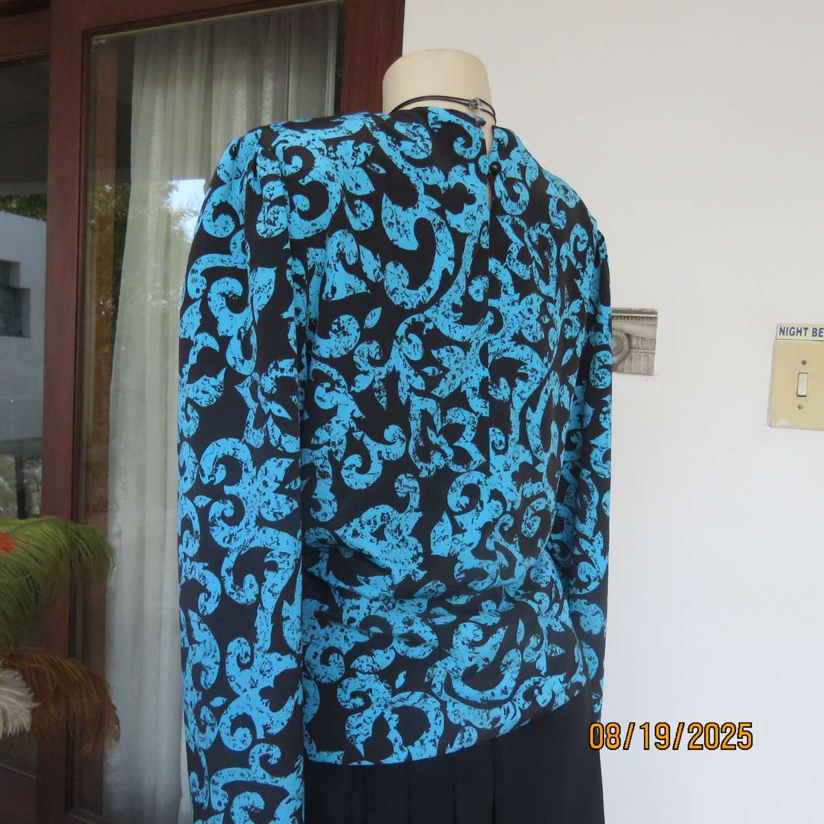 KRESIV peplum style black silky polyester with jade print top. Size 40