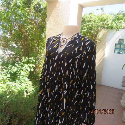 Black slip over tiered dress with white-mustard print. Soft polyester. Long sleeves. Size 32-34