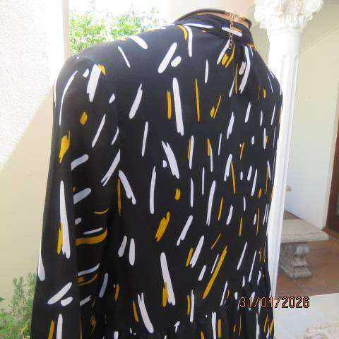 Black slip over tiered dress with white-mustard print. Soft polyester. Long sleeves. Size 32-34